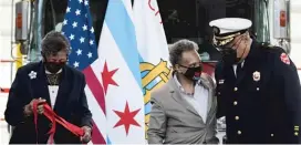  ?? PAT NABONG/SUN-TIMES PHOTOS ?? Mayor Lori Lightfoot speaks to retiring Chicago Fire Department Commission­er Richard Ford while Ald. Carrie Austin holds a ribbon during the opening ceremony of Engine Company 115’s new firehouse.