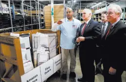  ?? JOHN MINCHILLO/ THE ASSOCIATED PRESS ?? Vice President Mike Pence and Health and Human Services Secretary Tom Price, right, tour the Frame USA facility Thursday in Springdale, Ohio.