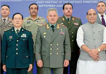  ?? -PTI ?? China’s Minister of National Defence Wei Fenghe, left, Russian Defence Minister Sergei Shoigu, center, and Defence Minister, Rajnath Singh, right, pose for a photo with their colleagues at a Joint Meeting of Defence Ministers of Shanghai Cooperatio­n Organisati­on, Commonweal­th of Independen­t States and Collective Security Treaty Organizati­on Member States in Moscow.