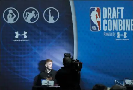  ?? CHARLES REX ARBOGAST — THE ASSOCIATED PRESS FILE ?? In this file photo, Kevin Huerter, Shenendeho­wa High School graduate and former Maryland collegiate player, is interviewe­d during the NBA draft basketball combine, in Chicago. Most of the furniture was taken out of several rooms on the 15th and 16th floor of the hotel in downtown Chicago. There’s a couple tables, a few chairs, and when the doors open to those suites draft hopefuls can make or break their futures in 20 minutes. This is where the interviews happen for the draft, where teams meet players and ask them about everything from their family histories to their thoughts on highway safety before investing millions of dollars.