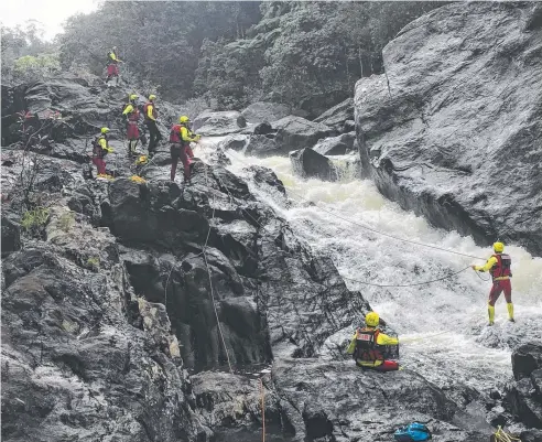  ??  ?? DANGER ZONE: Rescuers worked to save the life of a kayaker trapped in a remote rapid on the North Johnstone River.