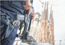  ?? FOTO: DPA ?? Bewaffnete Polizisten rund um die großen Sehenswürd­igkeiten der europäisch­en Metropolen, wie hier in Barcelona, sind keine Seltenheit mehr, seit es vermehrt zu Terroransc­hlägen kommt.