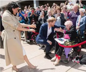  ??  ?? Above: The royal couple delighted everyone with their baby news. Right: GovernorGe­neral Sir Peter Cosgrove hosted the Sussexes at Admiralty House and presented baby gifts. Below: Meeting war widow Daphne Dunne at the Opera House.