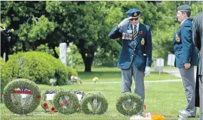  ?? MATHEW MCCARTHY WATERLOO REGION RECORD ?? Paul Baker, left, salutes after placing a wreath at the cenotaph at Parkview Cemetery in Waterloo on Sunday. Veterans and Royal Canadian Legion members gathered to mark Decoration Day.