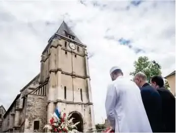  ??  ?? Muslim worshipper­s turned up at the church where Father Jacques was murdered to observe a minute’s silence