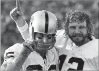  ?? THE ASSOCIATED PRESS FILE PHOTO ?? Receiver Fred Biletnikof­f, left, and quarterbac­k Ken Stabler celebrate after the Raiders defeated the Vikings in Super Bowl XI.