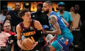  ?? Photograph: Dale Zanine/USA Today Sports ?? Atlanta Hawks guard Trae Young, left, controls the ball while defended by Charlotte Hornets forward Cody Martin during the first half of Wednesday’s play-in game.