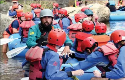  ??  ?? Rafting guide Kyle Lester teaches a group basic safety measures and rowing techniques June 23 before floating down the river.