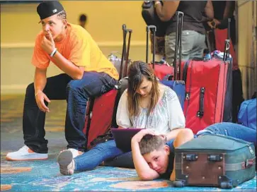  ?? Joe Cavaretta South Florida Sun Sentinel ?? PASSENGERS are stranded in Fort Lauderdale, Fla., in 2010 during a strike by pilots for Spirit Airlines.