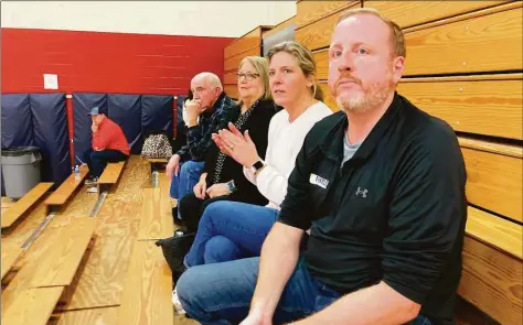  ?? Andy Tsubasa Field / Hearst Connecticu­t Media ?? On Thursday, Matthew and Liz Holcomb, parents of a Roger Ludlowe Middle School girls basketball player, sat on the bleachers after Liz drove five players to Thursday's game at Jockey Hollow Middle School.