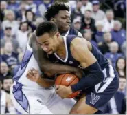  ?? NATI HARNIK — THE ASSOCIATED PRESS ?? Villanova’s Phil Booth, front, and Creighton’s KalebÂ Joseph, rear, struggle for the ball during the second half of an NCAA college basketball game in Omaha, Neb., Sunday.