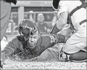  ?? Jayne Kamin-Oncea Getty Images ?? LORENZO CAIN is tagged out by Austin Barnes of the Dodgers after a throw by Enrique Hernandez.