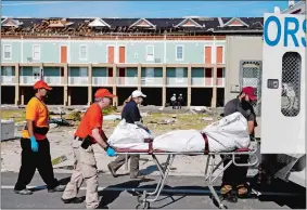  ?? DAVID GOLDMAN/AP PHOTO ?? A body is removed Friday after being discovered during the search of a residentia­l structure in Mexico Beach, Fla., in the aftermath of Hurricane Michael.