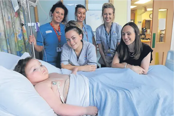  ??  ?? Blake in Ninewells Hospital along with mum Jenny, right, and NHS Tayside staff.