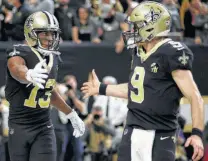  ?? Chris Graythen / Getty Images ?? The strong chemistry between Saints receiver Michael Thomas, left, and quarterbac­k Drew Brees was on display Sunday.