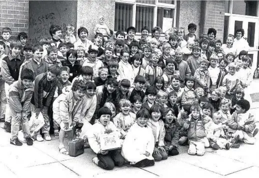  ??  ?? Cases packed, Mastrick summer playscheme members give a cheer before boarding the bus for an outing to Huntly Park in July 1987