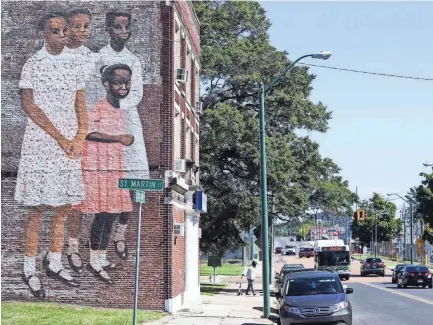  ??  ?? A monumental photograph­ic reproducti­on of Carroll Cloar, “Wedding Party,” 1971, is seen pasted onto the building at 154 G.E. Patterson Ave. BRAD VEST / THE COMMERCIAL APPEAL