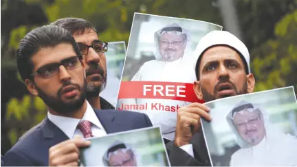  ?? (Murad Sezer/Reuters) ?? HUMAN RIGHTS ACTIVISTS and friends of Saudi journalist Jamal Khashoggi hold his picture during a protest last week outside the Saudi Consulate in Istanbul.