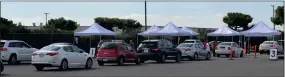  ?? RECORDER PHOTO BY ALEXIS ESPINOZA ?? It was a busy day for volunteers and county employees who staffed the vaccinatio­n site in the Portervill­e College parking lot on Wednesday where hundreds of people received their second dose of the COVID-19 vaccine.