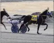  ?? PAUL POST — MEDIANEWS GROUP ?? Horses speed around the harness track at Saratoga Casino Hotel.