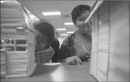  ?? BEA AHBECK/NEWS-SENTINEL ?? lIsaiah Williamjon­es and Juan Guzman Look at a multimedia haunted houses built with popsicle sticks at McNair High School in Stockton on Tuesday.