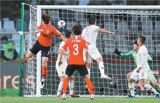  ?? Xinhua-Yonhap ?? South Korea’s defender Kim Min-Jae, left, scores against China during the AFC Asian Cup group C soccer match between South Korea and China at Al Nahyan Stadium in Abu Dhabi, United Arab Emirates, Wednesday. South Korea won 2-0.