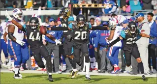  ?? Associated Press photo ?? Jacksonvil­le Jaguars outside linebacker Myles Jack (44), cornerback Jalen Ramsey (20) and defensive back Tyler Patmon (23) celebrate Ramsey's intercepti­on of a pass from Buffalo Bills quarterbac­k Nathan Peterman intended for wide receiver Deonte...