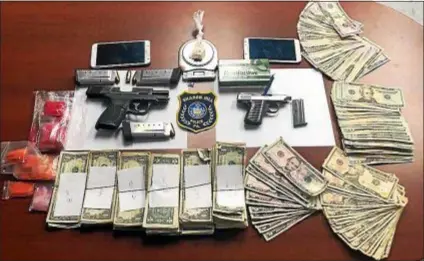  ?? SUBMITTED PHOTO ?? This is part of the cache of guns, drugs and money seized by county detectives during a recent drug arrest.