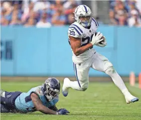 ?? ANDREW NELLES/TENNESSEAN ?? Indianapol­is Colts running back Jonathan Taylor (28) gets away from Titans linebacker David Long Jr. during the fourth quarter at Nissan Stadium on Sunday in Nashville.