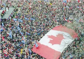  ?? GORDON BECK/MONTREAL GAZETTE FILES ?? An oversized maple leaf flag marks a rally that drew crowds to Place du Canada in support of Canadian unity on Oct, 27, 1995.
