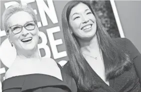  ??  ?? Meryl Streep arrives for the Golden Globes with Ai-jen Poo, head of the National Domestic Workers Alliance. VALERIE MACON/AFP/GETTY IMAGES