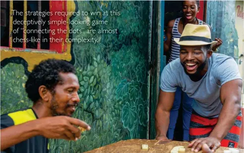  ??  ?? Catch a friendly domino game while in St. George’s, Grenada.