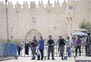  ?? [AP PHOTO] ?? Israeli border police officers stand guard Saturday outside the Damascus Gate in Jerusalem’s Old City.