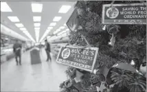  ??  ?? A Christmas tree is adorned with the company’s mascot at the new Buc-ee’s, which spans 56,000 square feet. Customers can buy everything from clothing to hoagies to fresh fudge at the store.