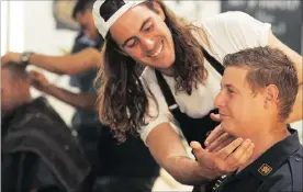  ??  ?? GOOD CAUSE: Cancer survivor Timothy Hart being shaved by Jonny “Barber” Joel to raise awareness of men’s health issues.