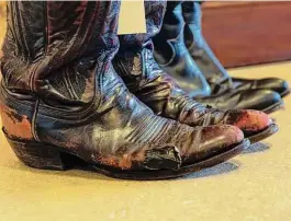  ?? ?? McMurtry’s love of cowboy boots will be on display at the auction. These well-worn examples includes a pair held together with electrical tape.