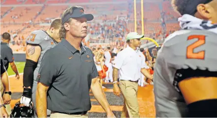  ??  ?? Oklahoma State football coach Mike Gundy walks off the field after last season's win against McNeese State at Boone Pickens Stadium in Stillwater. [SARAH PHIPPS/ THE OKLAHOMAN]