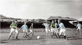  ??  ?? Left: Cyril Freaney, who played in the 1955 All-Ireland final, pictured with Dublin footballer Cian O’Sullivan and the Sam Maguire Cup. Above: An action shot from the 1955 final with Freaney (2nd from right), and fellow Dubs Kevin Heffernan (centre) and Des Ferguson (third from left). The match was won by Kerry 0-12 to 1-6 in front of a crowd of 87,000 in Croke Park.