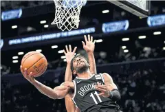 ?? AFP ?? The Nets’ Kyrie Irving goes in for a lay-up against the Timberwolv­es.