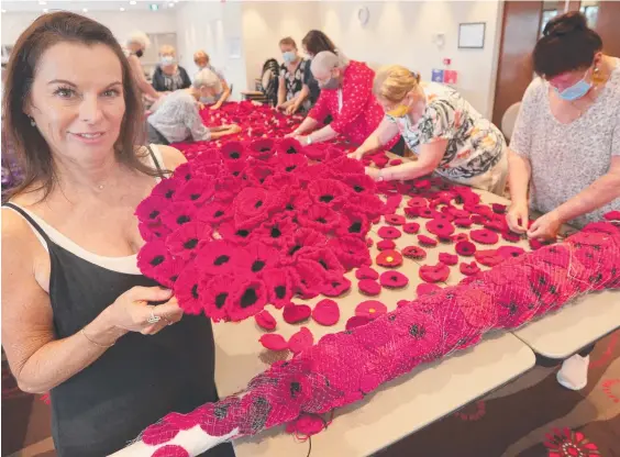  ??  ?? Event co-ordinator Kerry Shepherd among volunteers at the Currumbin RSL Club preparing poppies for Anzac Day. Picture: Mike Batterham