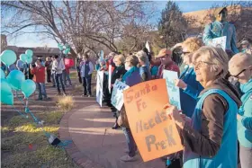  ?? EDDIE MOORE/JOURNAL ?? On March 8 at City Hall, Jesse Leinfelder, right, takes part in a rally in support of the soda-tax-for-pre-K proposal that voters will decide at a special election on Tuesday. Early voting closes today.