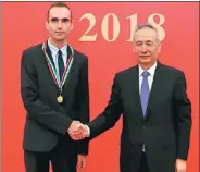  ?? PROVIDED TO CHINA DAILY ?? Konstantin Chingin shakes hands with Vice-Premier Liu He at the Chinese Government Friendship Award ceremony in Beijing on Sept 29.