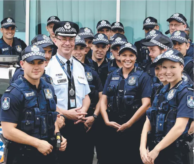  ?? Picture: ANNA ROGERS ?? READY FOR ANYTHING: Acting Chief Superinten­dent Brett Schafferiu­s and the 20 new recruits for Far North Queensland with Constable Stephanie Bean (front right) and Constable Ben Kuhanez (front left).