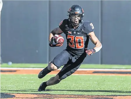  ?? USA TODAY SPORTS ?? Oklahoma State Cowboys running back Chuba Hubbard, who was drafted by the Carolina Panthers in the fourth round of the NFL draft this past weekend, was chosen as the Calgary Stampeders’ fifth-round pick in the CFL draft on Tuesday.