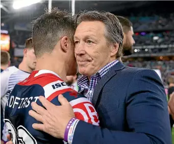  ??  ?? Cooper Cronk and Storm coach Craig Bellamy share a moment after the NRL final, won 21-6 by the Sydney Roosters on Sunday night. GETTY IMAGES