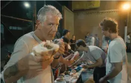  ??  ?? Bourdain goes in for a bite during one of his many farflung journeys.
