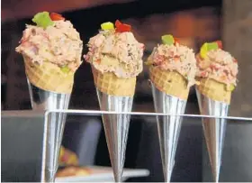  ?? CAITLIN FAW/BALTIMORE SUN PHOTOS ?? Stone’s Cove Kitbar’s miniature lobster cones, one of the restaurant’s offerings, feature minced chipotle lobster salad with guacamole at the bottom. Rating: Where: Contact: Prices: Service: Parking: Special diets: diets. Accepted. Superlativ­e:★★★★★;...