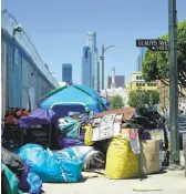  ?? Frederic J. Brown / AFP / Getty Images ?? Tents housing the homeless and their belongings crowd a street corner in Los Angeles. The state’s housing crisis has been years in the making.