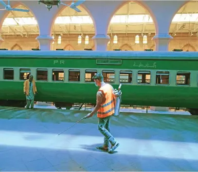  ?? Picture: AFP ?? A worker disinfects Lahore railway station in Pakistan as train services prepare to resume yesterday after the government eased a nationwide lockdown imposed to stop the spread of the coronaviru­s.