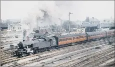  ?? PICTURES: PETER TUFFREY COLLECTION ?? ROAD MEETS RAIL: From left, Denaby Main crossing steam locomotoiv­e no 63704 passing through in March 1961; Askern Colliery with locomotive Rossington No1 in 1974; Loco 42495 at Skipton station, April 1960.